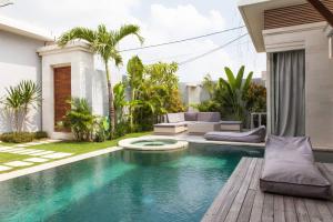 a swimming pool in the backyard of a house at Villa KMEA 4 in Seminyak