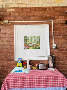 a table with a red and white checkered table cloth at เกรซรูม รีสอร์ท (Grace Room Resort) 