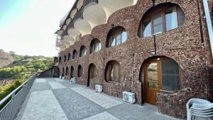 a red brick building with a walkway next to it at The Hill Guest House in Yerevan