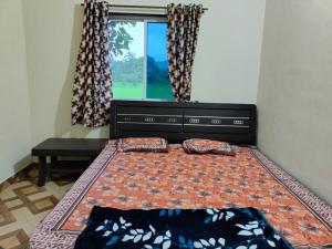 a bed with two pillows on it in a bedroom at Raigad Agro Park in Mahād +38 photos