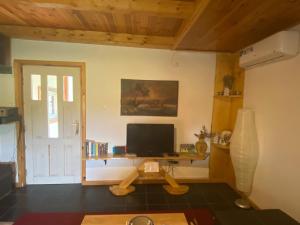 a living room with a desk with a television at Cute lodge in Zeta in Mahala