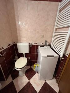 a small bathroom with a toilet and a sink at Apartman JAGODA in Varaždin