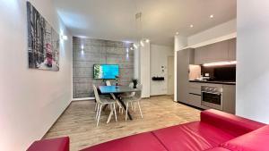 a living room with a table and chairs and a kitchen at LuxurySmart Apartment in Misano Adriatico