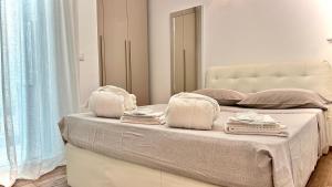 a bedroom with a bed with towels on it at LuxurySmart in Misano Adriatico