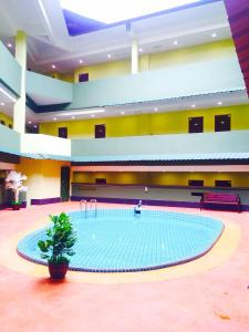 a large swimming pool in a large building at Riverview Hotel in Bahau