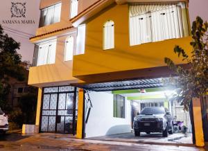 a car parked in front of a yellow building at SSAMANA MARÍA APARTMENT 202 in Arequipa