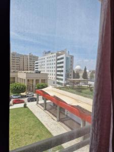 a view of a city from a window at Appart de Luxe au Centre Urbain Nord in Tunis