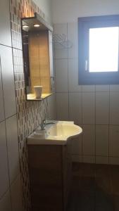 a bathroom with a sink and a mirror at Marianthi Studios in Áno Meriá