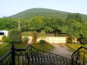 a view of a yard with a fence and a mountain at Martvili Canyon Room for up to 3 guests in Martvili