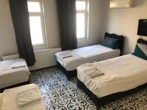a room with three beds and two windows at Reydel Hotel in Istanbul +121 photos