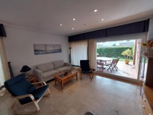 a living room with a couch and a table at MojacarProperty, Apto Mirador Vera Playa in Vera
