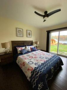 a bedroom with a bed and a ceiling fan at Four Season Waterfront Muskoka Retreat in Bracebridge