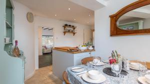 a dining room with a table and a kitchen at Bell Cottage - Pretty Period Cottage DOG FRIENDLY in Northallerton