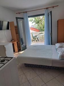 a bedroom with a bed and a view of a patio at Apartments Sabol Geist in Borovići
