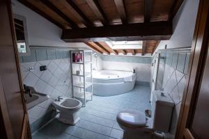 a bathroom with a tub and a toilet and a sink at YOUR APARTMENT IN FLORENCE in Florence +32 photos