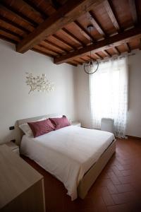 a bedroom with a large bed and a large window at YOUR APARTMENT IN FLORENCE in Florence