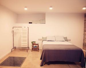 a bedroom with a bed and a mirror at La Dolce Vita. Boutique Apartment in Girona