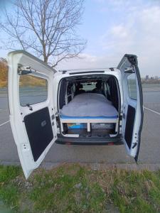 ein Lieferwagen mit offener Tür auf der Straße in der Unterkunft Marty's Campervan in Adliswil