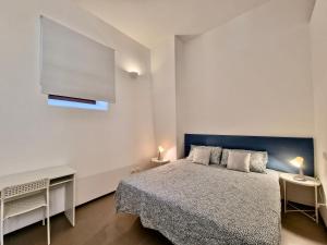 1 dormitorio con 1 cama y 2 mesas con lámparas en Casa Alferi by TraMonti Apartments, en LʼAquila