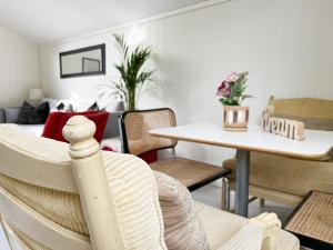 a living room with a table and a dining room at Brightside Apartment in Kristiansand