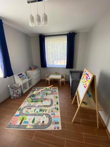a childs room with a crib and a chalkboard at Apartament Nova Gniewino in Gniewino
