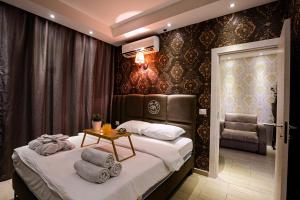 a bedroom with a bed with a table and a chair at Spa House Boutique Hotel - Petach Tikwa in Petaẖ Tiqwa