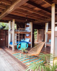 a porch of a house with bunk beds and chairs at The Fort Hostel in Don Diego