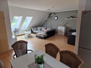 a living room with a table and chairs and a couch at Ferienwohnung Möllers Hof in Petershagen