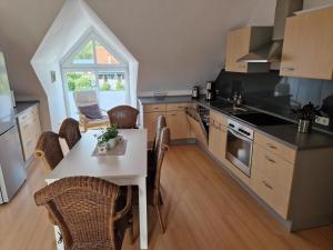 a kitchen with a table and chairs and a window at Ferienwohnung Möllers Hof in Petershagen