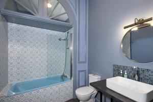 a bathroom with a sink and a tub and a toilet at H&ocirc;tel De France Et De Guise - 1891 in Blois