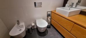 a bathroom with a toilet and a sink at Kriol Guest House in Praia