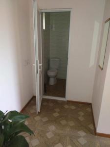 a bathroom with a toilet and a door to a room at Eco Aura in Vardenis