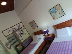 a small bedroom with two beds and a night stand at Blue Lizard House in San Andrés