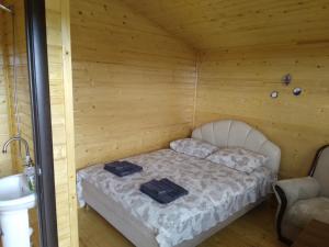 a room with a bed in a wooden cabin at Eco Aura in Vardenis