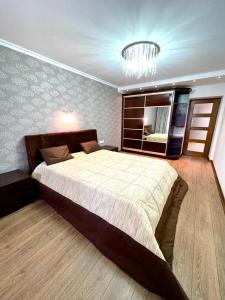 a bedroom with a large bed and a mirror at Marius Homestay in Chişinău