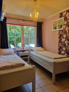a bedroom with two beds and a window at Holiday home bos en heide in Otterlo