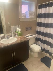 a bathroom with a sink and a toilet and a shower at Rockwood House in Nanaimo