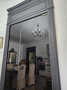 a mirror in a living room with a chandelier at Gropallo Palace Apartments - 4 Dreams 4 You - Pieno centro - Palazzo Nobiliare Storico in Genoa