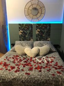 Una cama con un montón de rosas rojas. en Une Pause Douceur - Suite Orchidée, en Eyguières