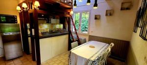 a kitchen with a counter and a table in it at Maisonnette Lac de Vassivière in Beaumont