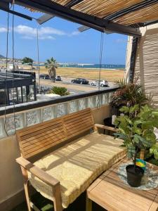 a bench on a balcony with a view of the beach at Luxury apartment with sea view in Marseille