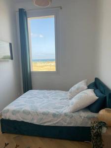 a bedroom with a bed and a window at Luxury apartment with sea view in Marseille