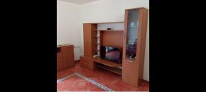 a living room with a tv in a wooden cabinet at Lovely y Cozy Apartments in Chulilla