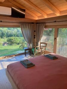 a bedroom with a large bed and a large window at Antico fienile in Belluno