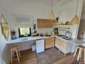 a kitchen with white appliances and wooden cabinets at Apartman Snežana Jugovo in Smederevo