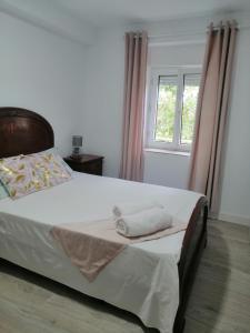 a bedroom with a large bed with a window at Villa Mayki 