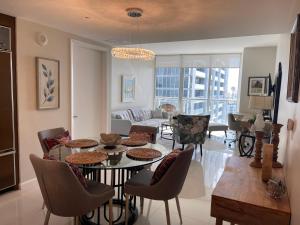 a living room with a table and chairs at Sun&Sea IconBrickell Unit in Miami
