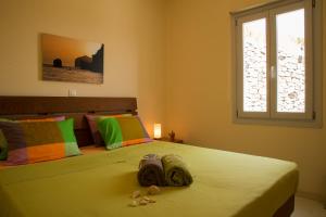 a bedroom with two beds and a window at Sea view houses in Éxo Goniá
