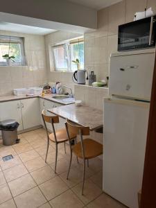 a kitchen with a table and a refrigerator at Casa Portocalie in Cisnădie