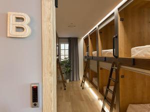a room with bunk beds with a b on the wall at The POD Suite Hostel in Valencia